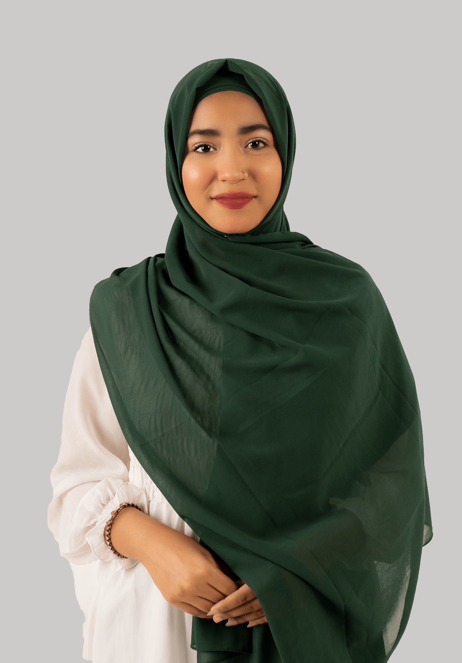 a women wearing georgette instant hijab with cap in dark green color front side.