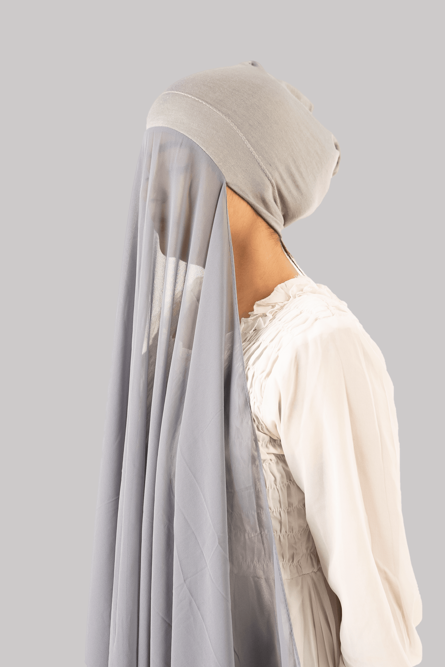 a women wearing instant hijab with cap in grey color georgette material side profile
