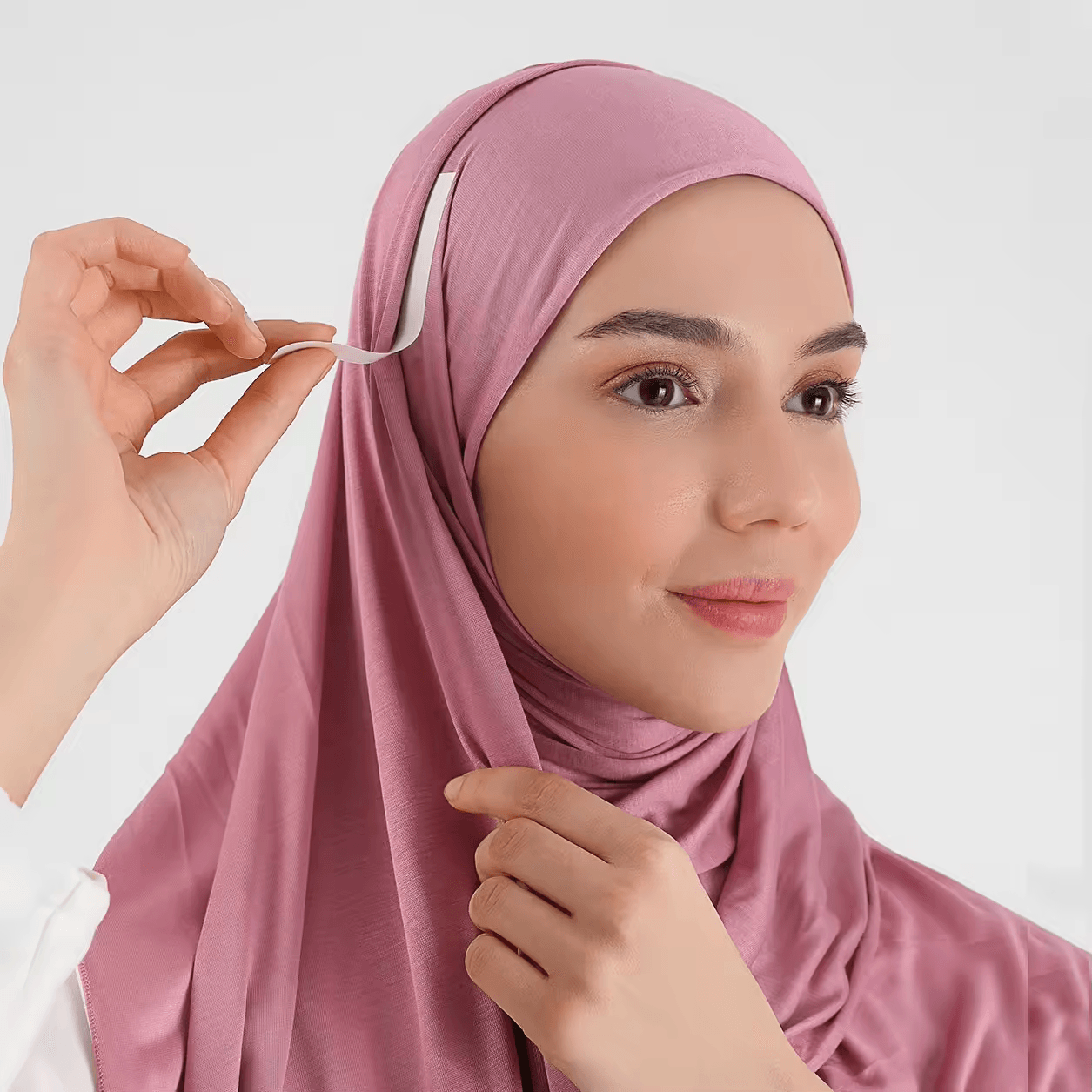 Model wearing a hijab secured with Double Sided Tape, showcasing its invisible support and polished appearance.