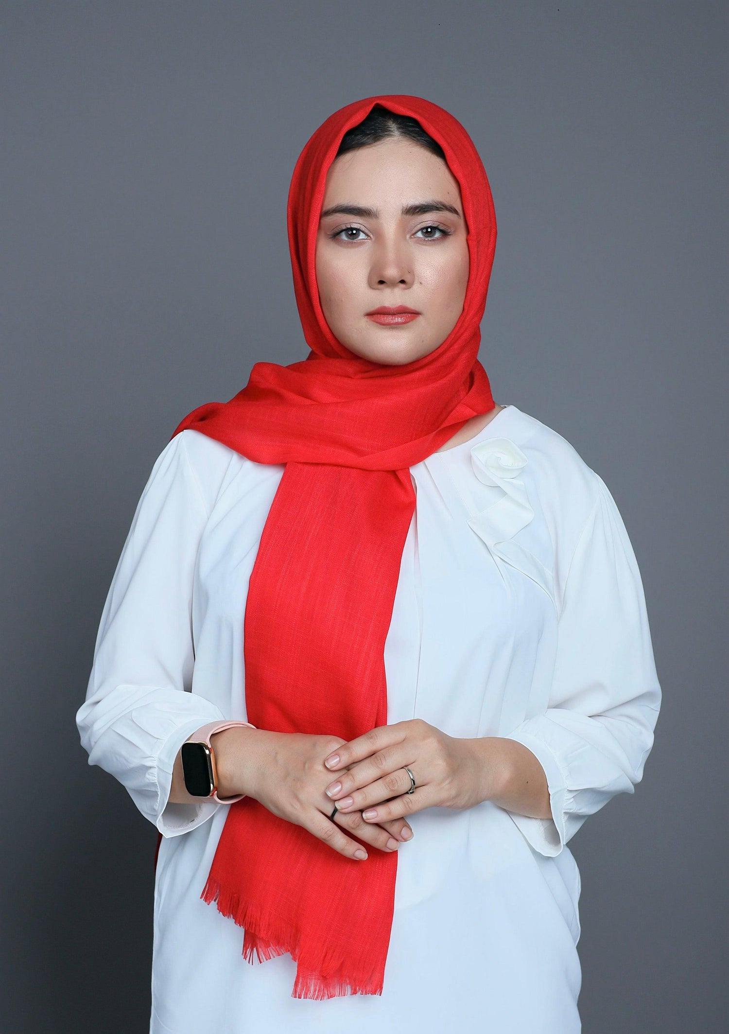 A fashionable woman wearing a Turkish Viscose Hijab in vibrant Watermelon shade, showcasing its luxurious texture and style.