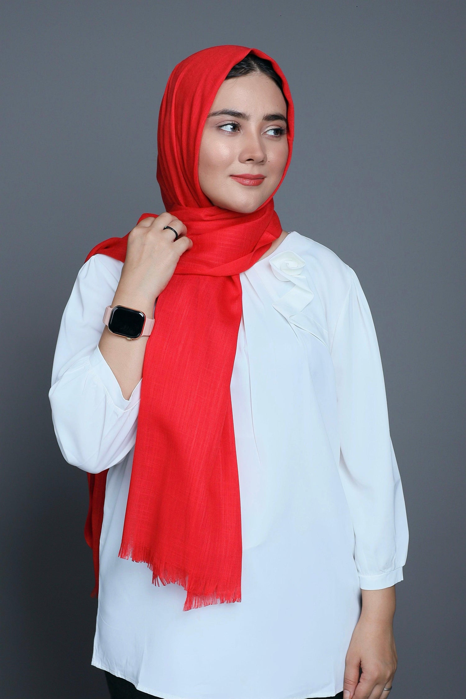 Close-up of the Watermelon Turkish Viscose Hijab draping elegantly over a stylish outfit, highlighting its softness and color.