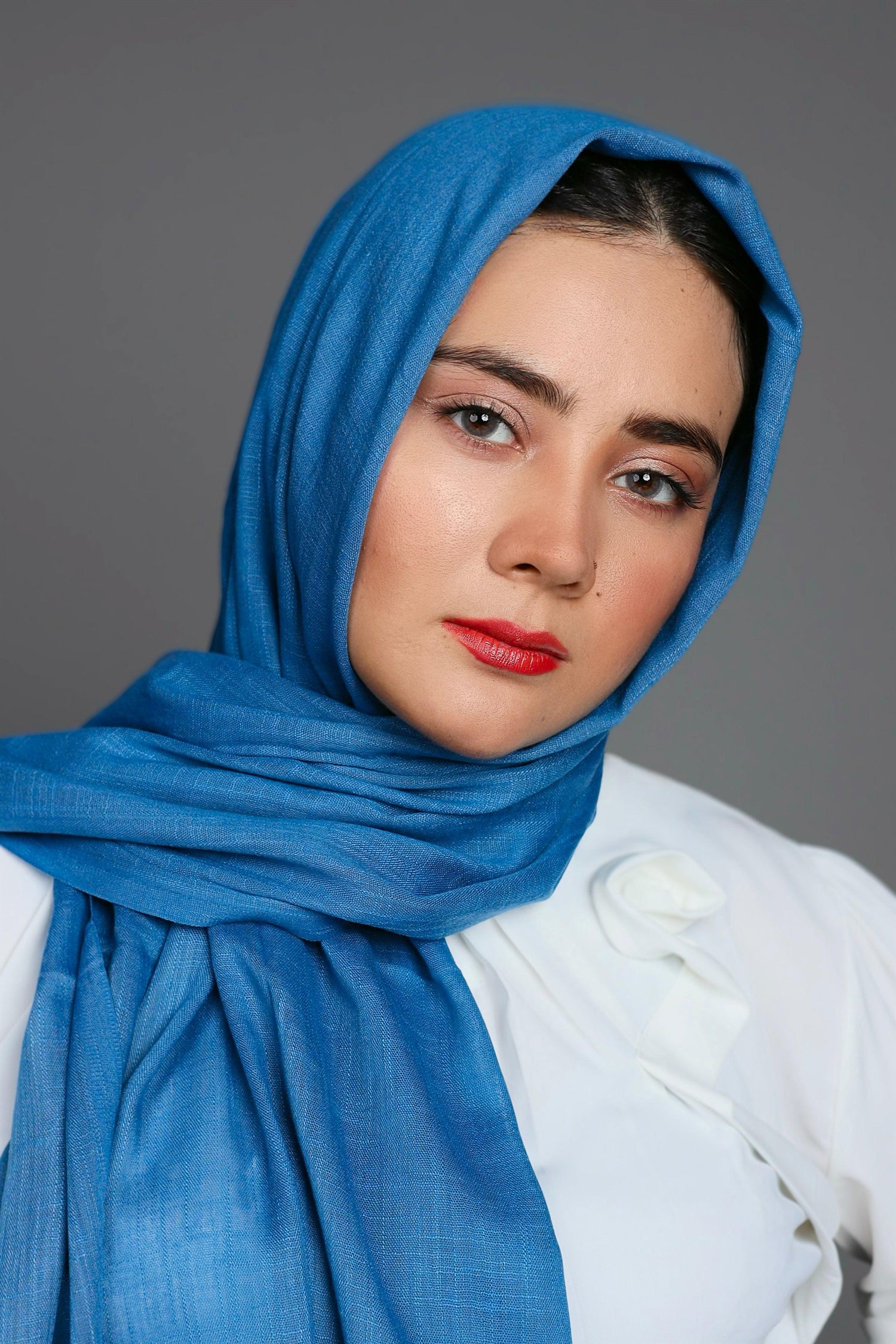 Stylish hijabi draped in a serene Lake Blue scarf, highlighting the elegant fabric and design.