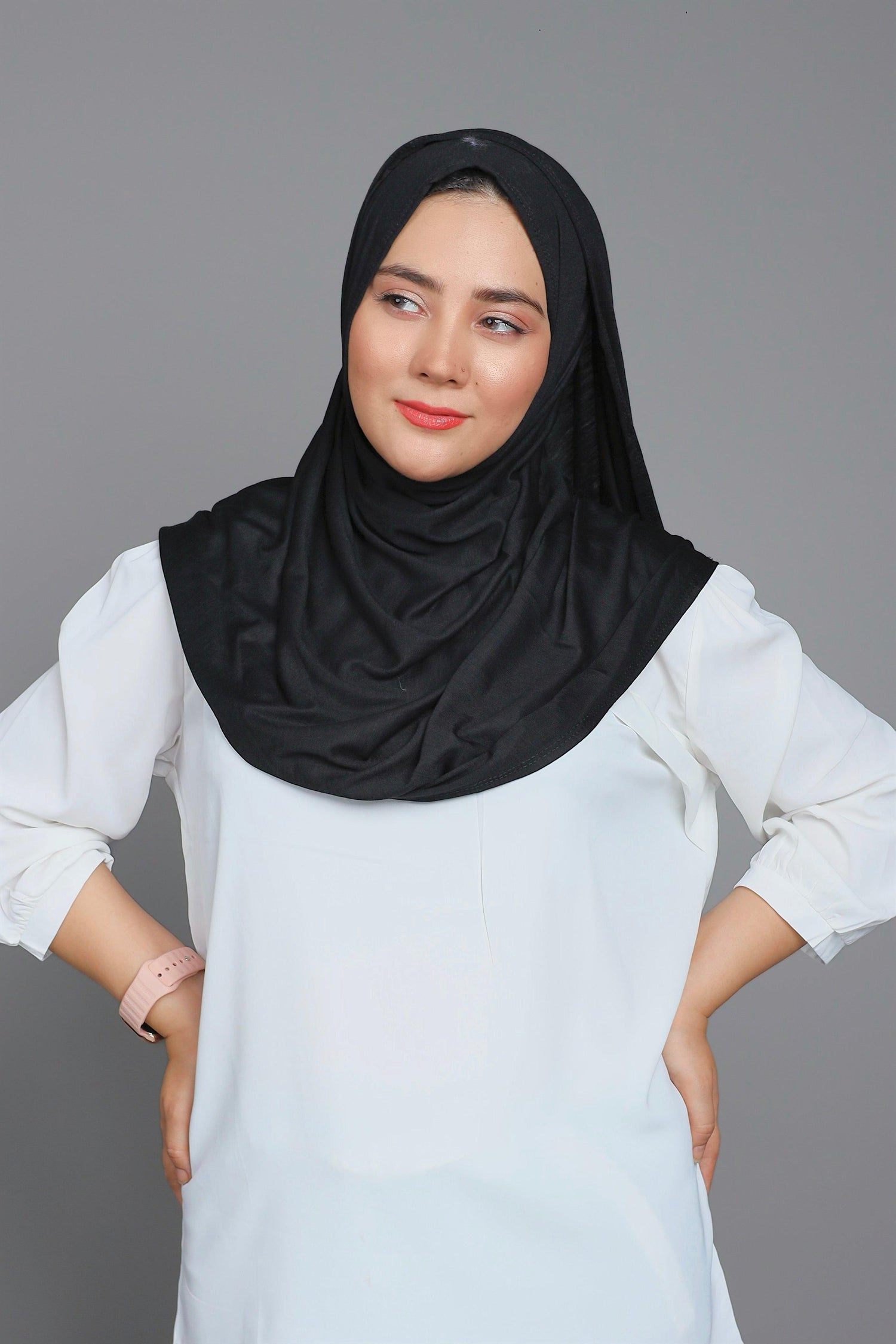 Girl Wearing Black Jersey Hijab. looking her right.