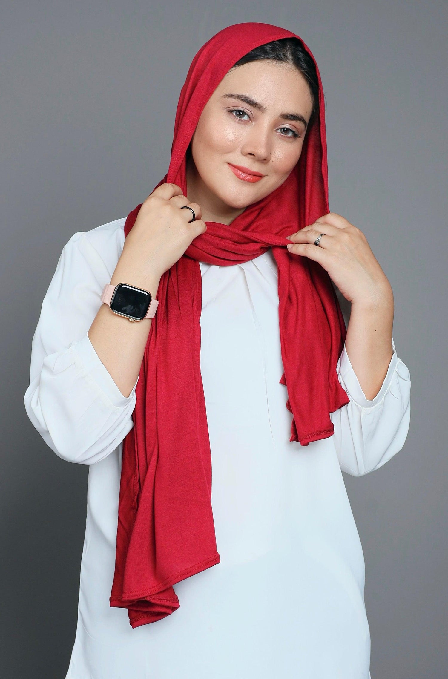 Chic woman in a Fuchsia Jersey Hijab looking her front.