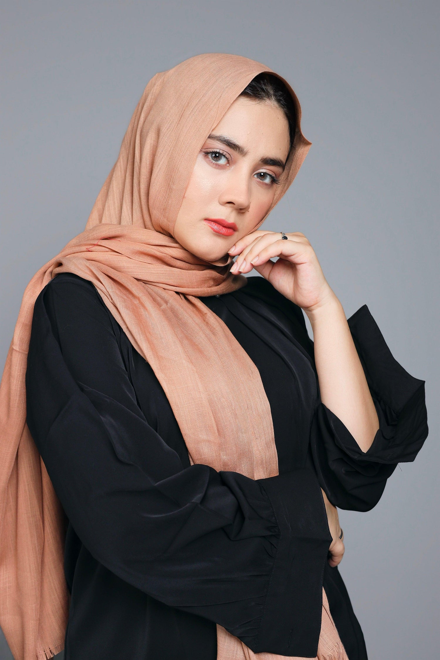 Woman wearing Hazelnut Cotton Viscose Hijab, styled elegantly around the head and shoulders.