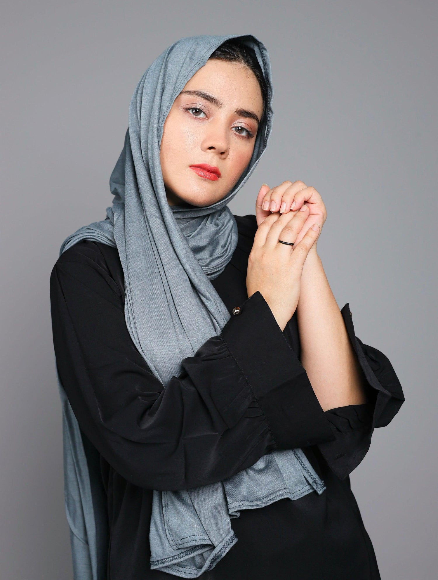 Woman wearing jersey hijab in grey shade.
