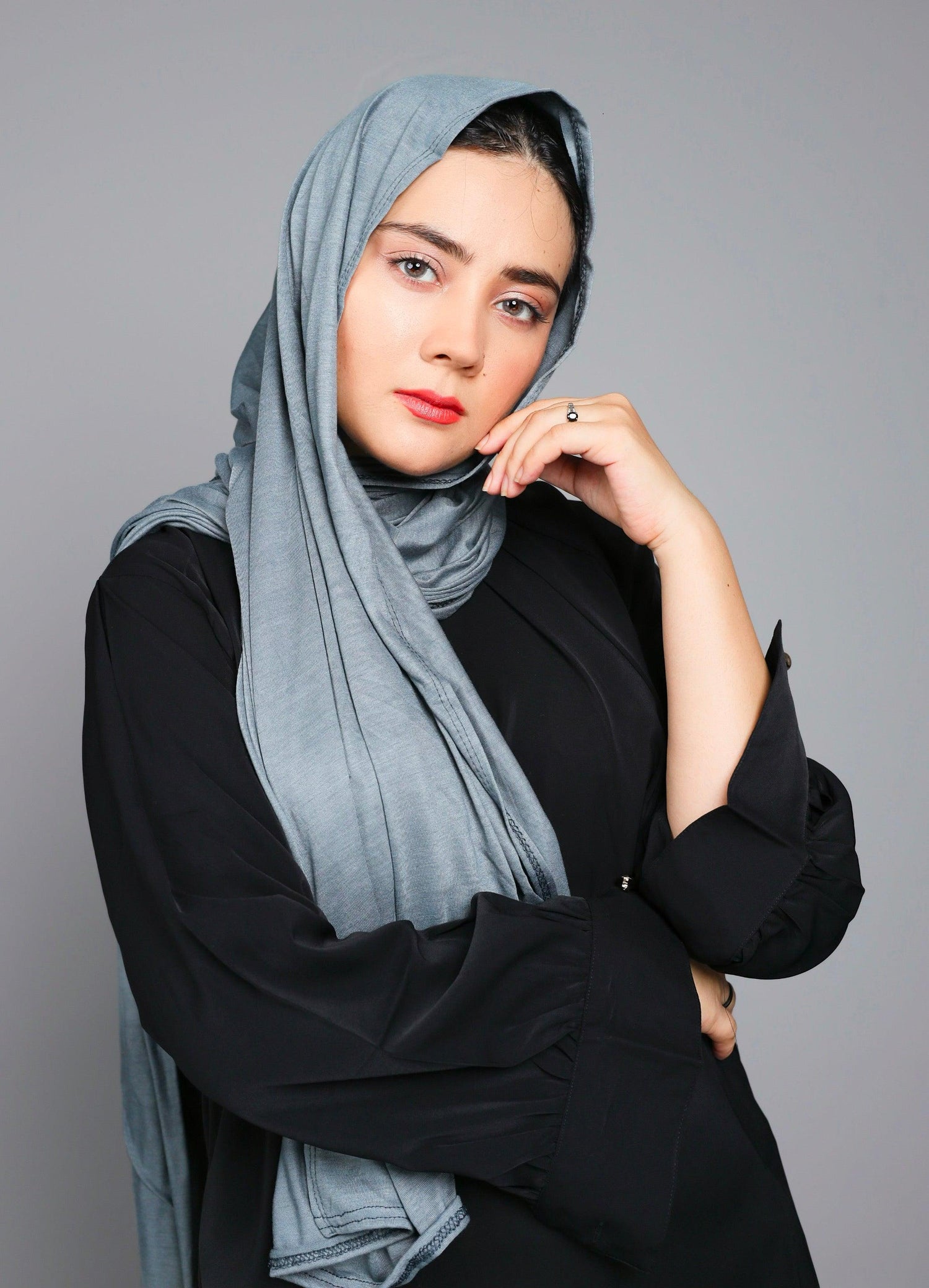 Jersey Hijab in grey. Elegant Woman wearing Jersey Hijab looking her front.