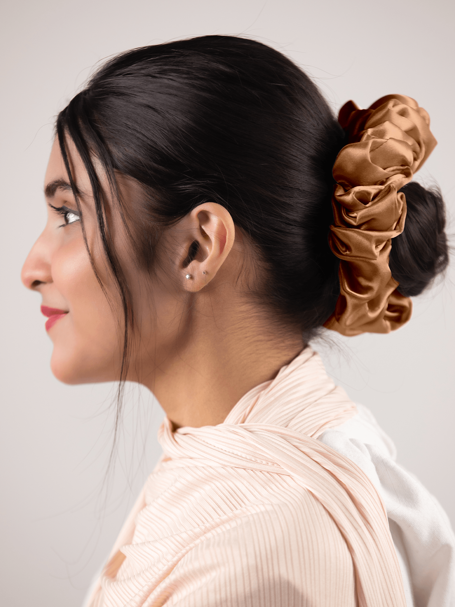 Silk Scrunchie in Toffy. Woman wearing stylish hair band.