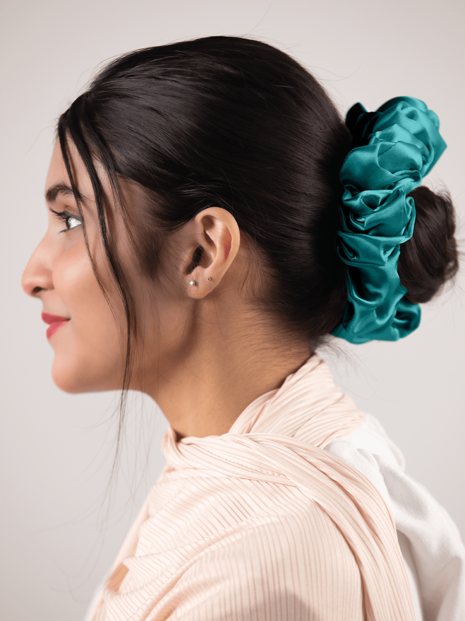 Silk Scrunchie in Turquoise. Woman wears scrunchie a stylish hair accessory.