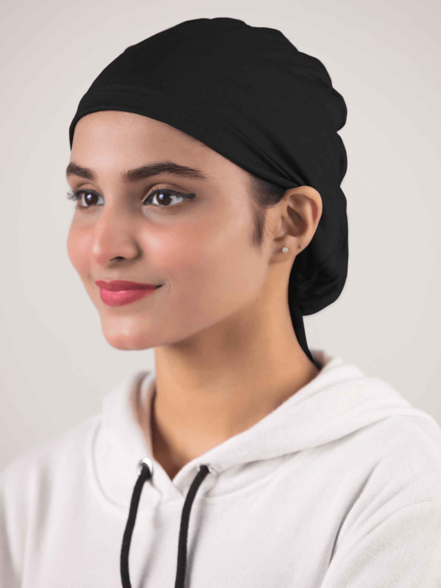 Girl wearing Black Ruched Hijab Cap breathable fabric and elegant ruching.
