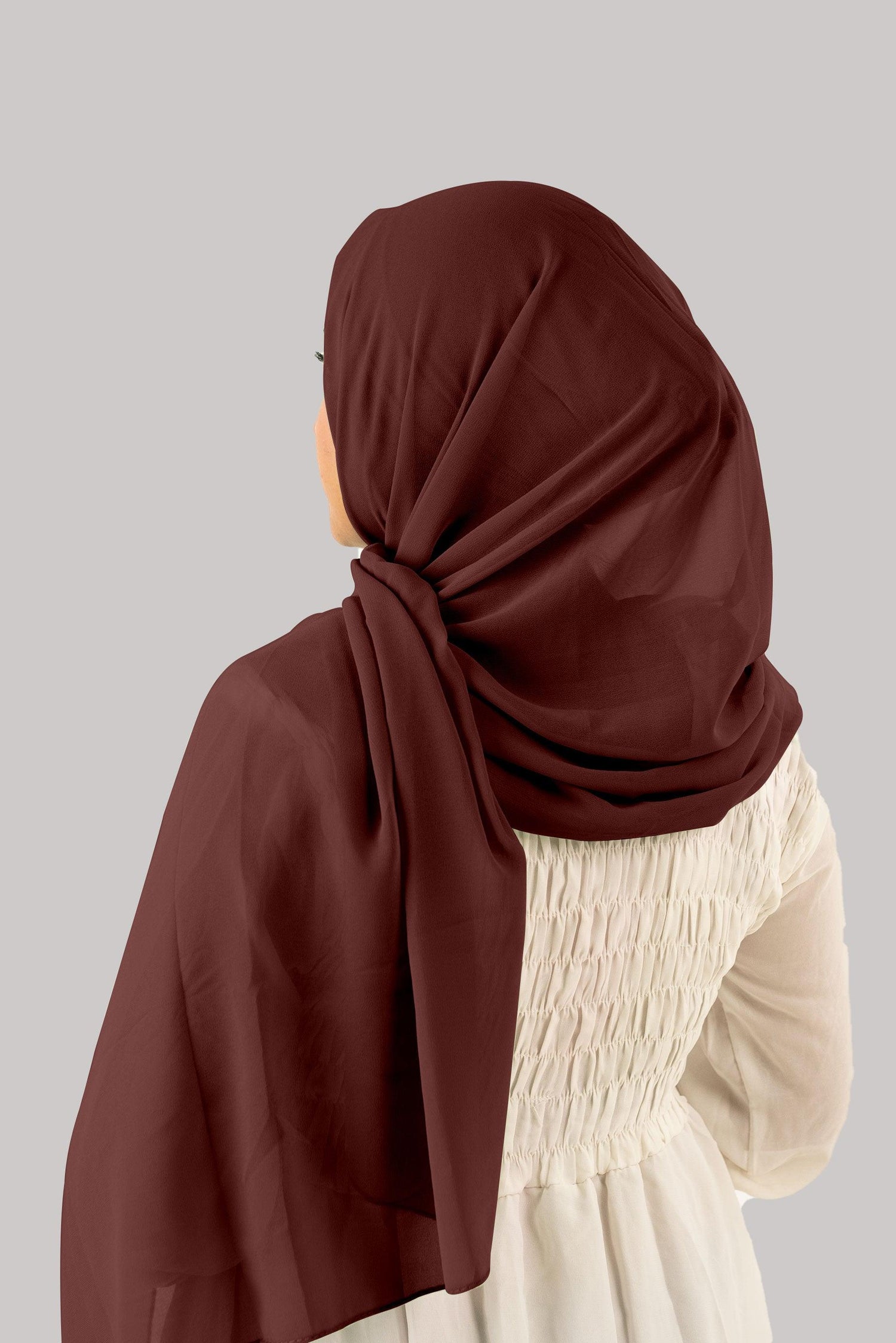 back view of a women wearing instant hijab with cap in nutella.