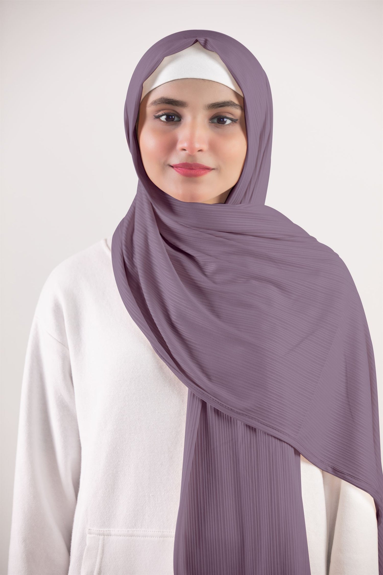 Woman showcasing a chic Ribbed Jersey Hijab in Dusty Pink.