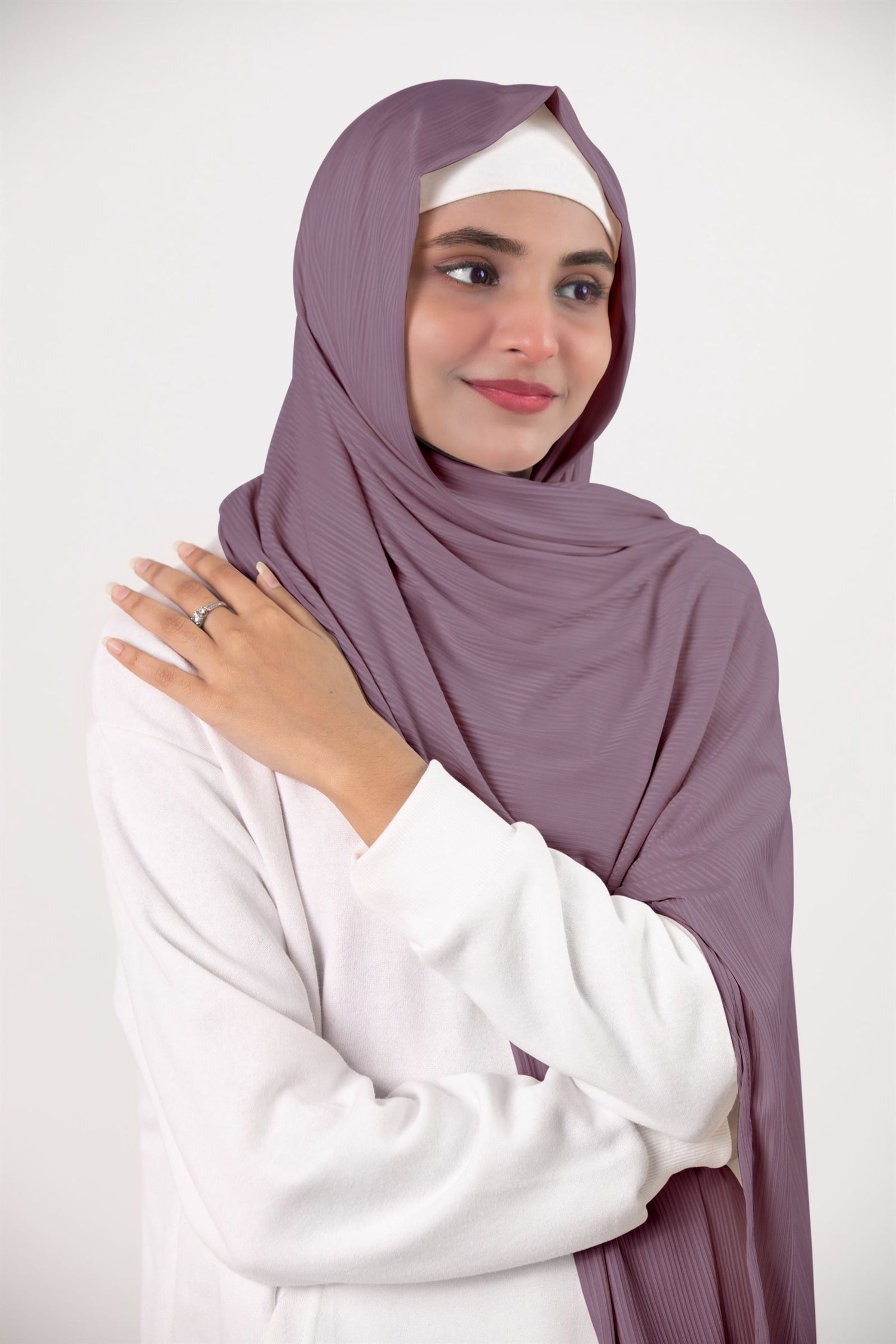 Modern hijabi draping an elegant Dusty Pink Ribbed Jersey Hijab.
