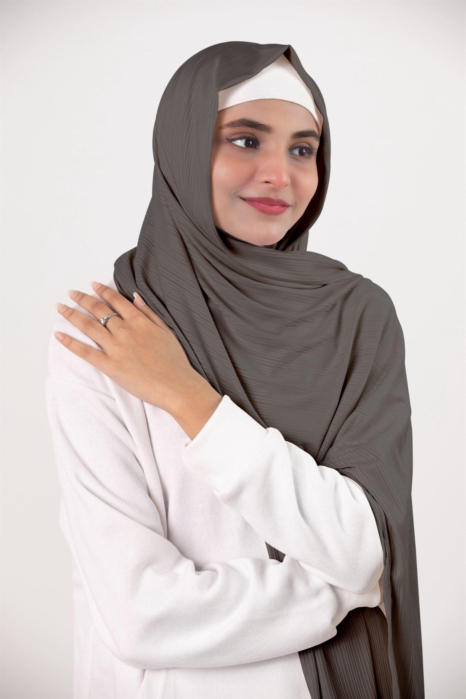 Ribbed Jersey Hijab in dusky sage. Fashion-forward hijabi draping it for an elegant appearance.