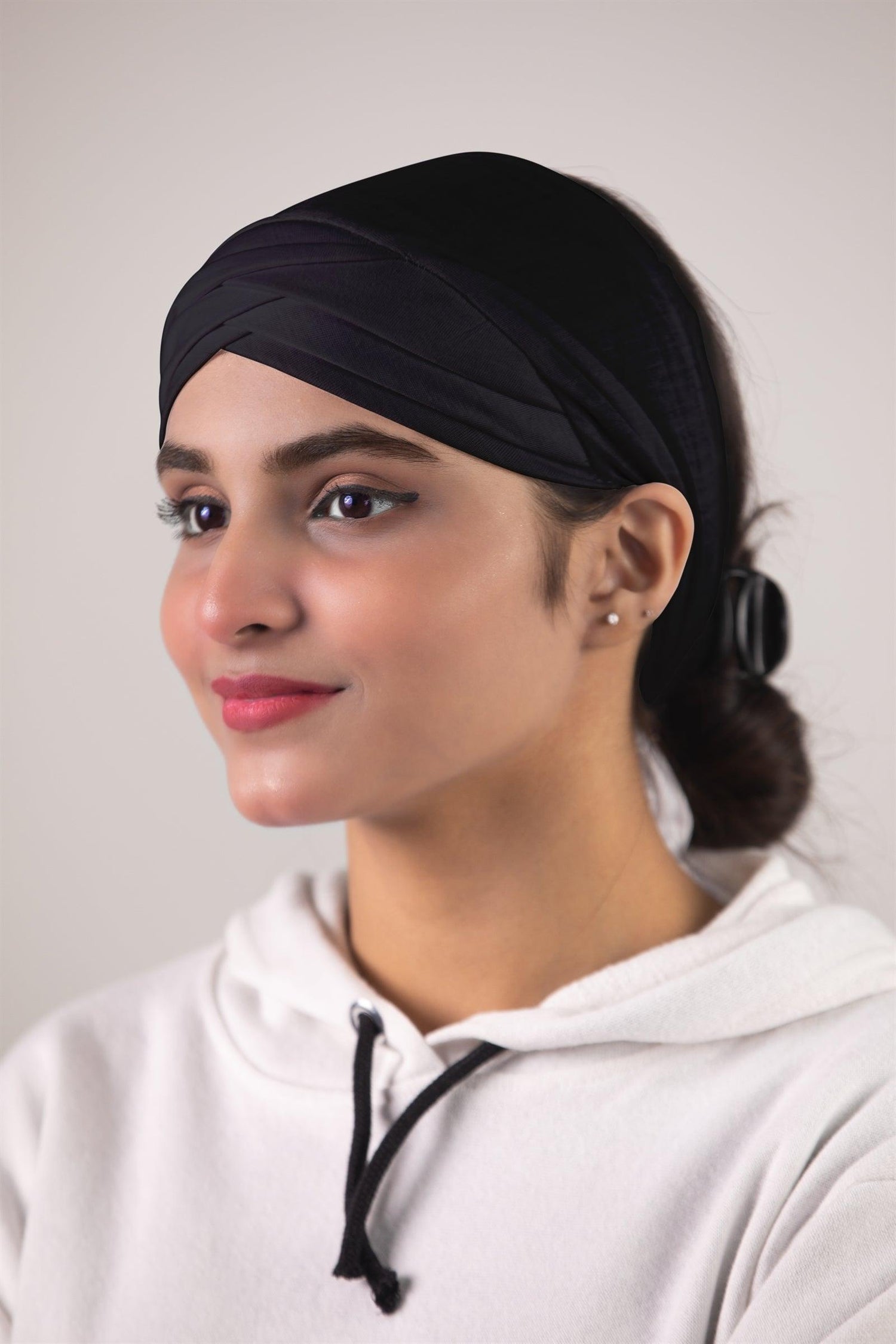 Woman Weating Criss Cross Hijab Cap in Black Color. Cross front style hijab undercap.