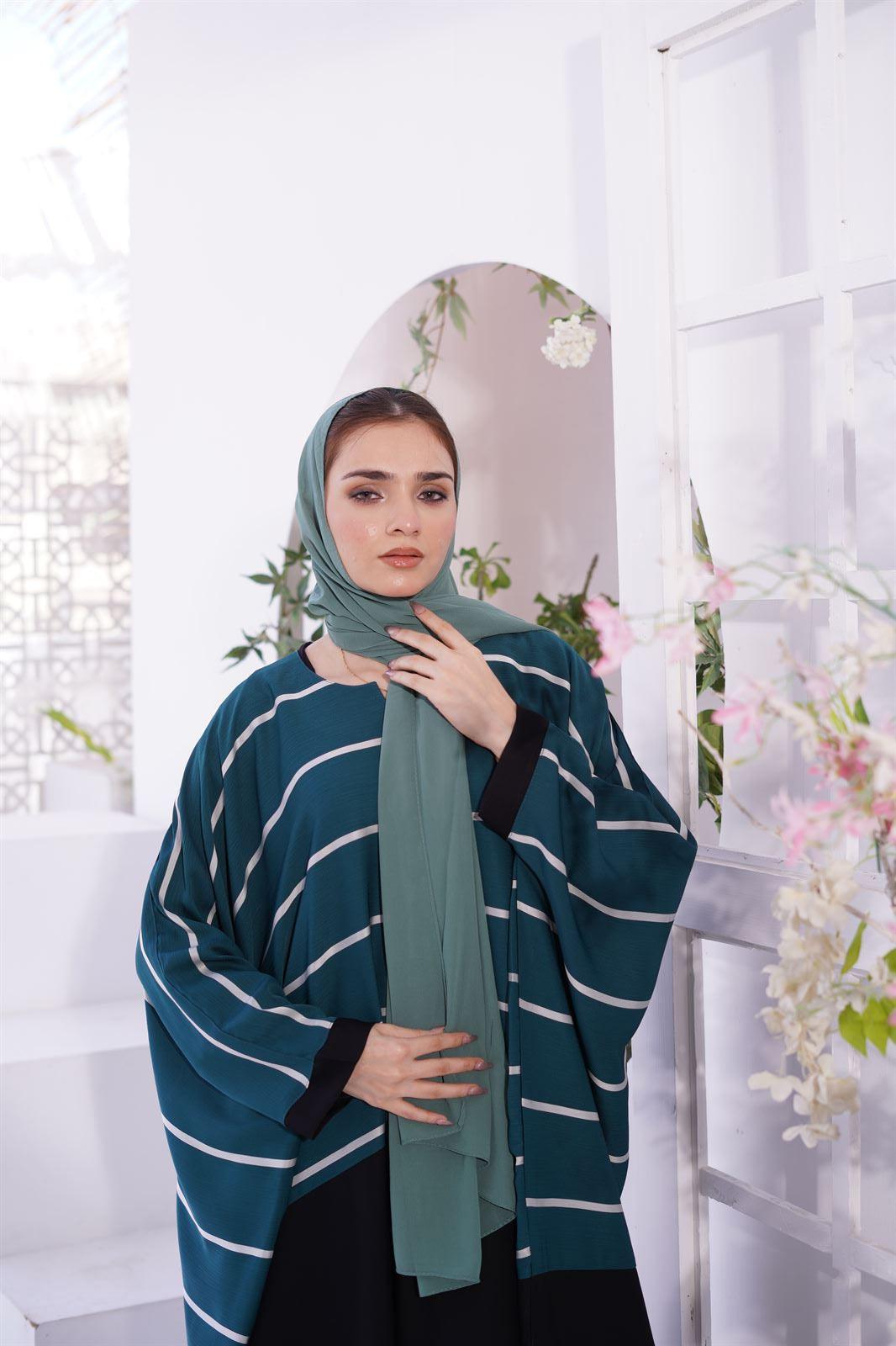 Abayas and Jilbabs. front view of a Girl wearing zoom line Jilbab in sage.