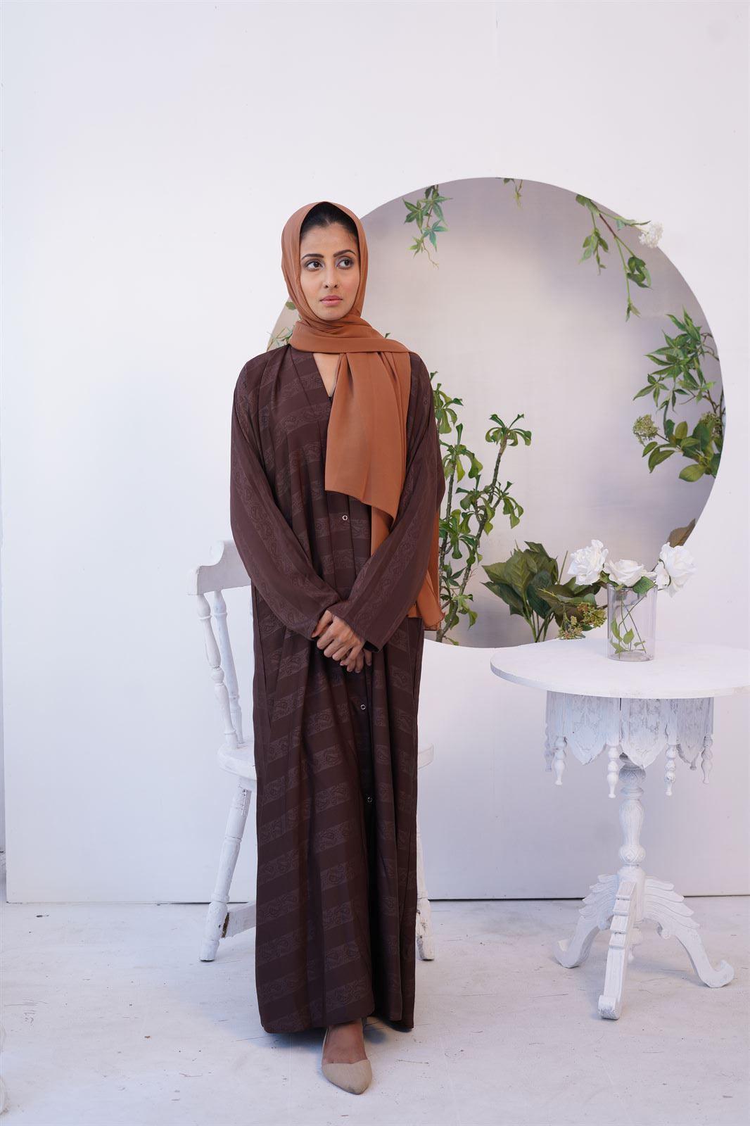 Girl wearing one of Zoom emboss Gown premium abayas.