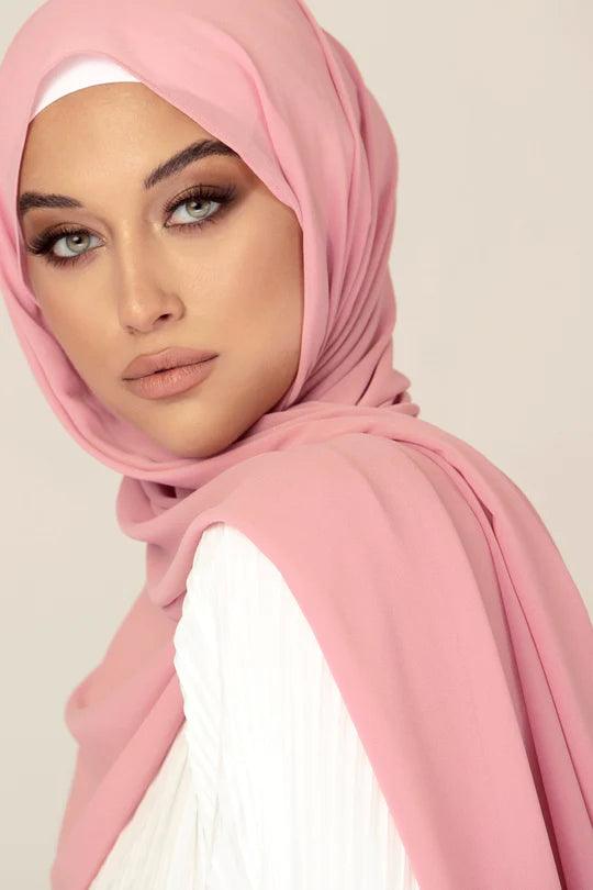 Georgette Hijab Online Pakistan, in ndue pnk color . a women wearing it with white top looking straight.