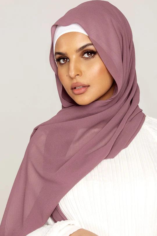 Georgette Hijab Online Pakistan, in dark mauve color . a women wearing it with white top looking her straight.
