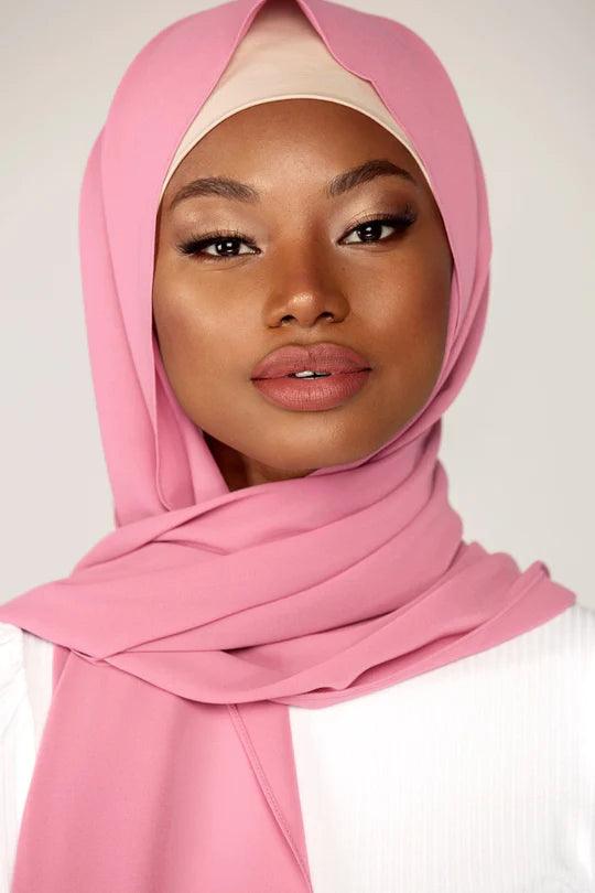 Georgette Hijab Online Pakistan, in blossom color. A woman wearing it with white top looking her STRAIGHT.