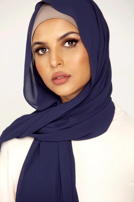 Georgette Hijab Online Pakistan in Navy blue. Girl styling on white top looking straight.