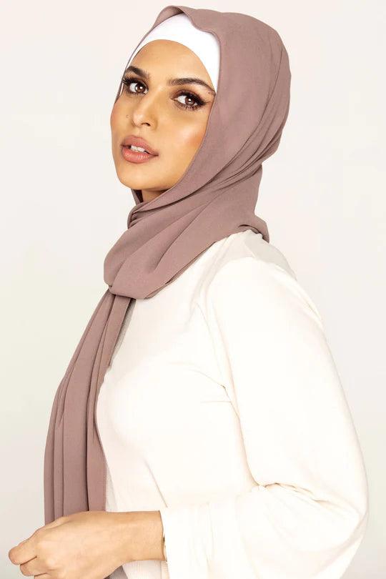 Georgette Hijab Online Pakistan, in taupe color . a women wearing it with white top looking straight.