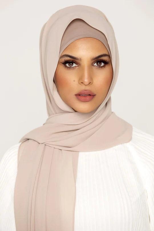 Georgette Hijab Online Pakistan, in MILKSHAKE color . a women wearing it with white top looking her straight