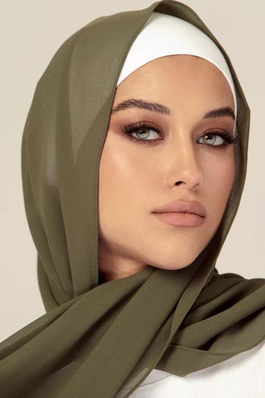 a women wearing Georgette Hijab, in sage colour, with white top.