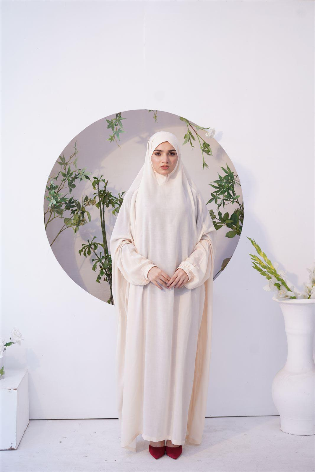 A girl wearing Namaz Chadar with Sleeves in cream color
