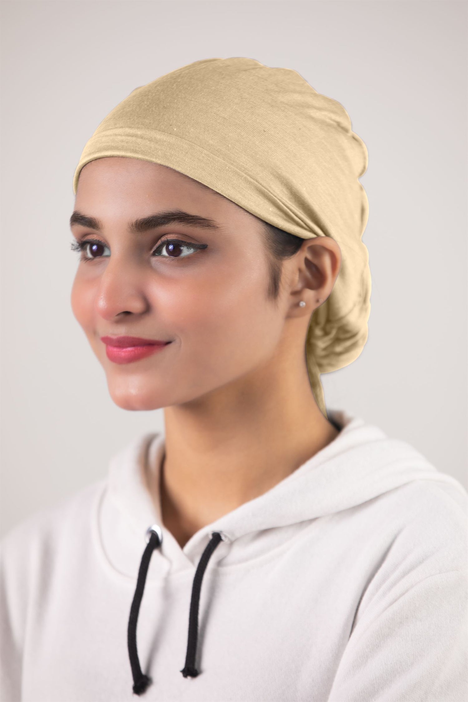 Woman wearing Elegant Fawn Ruched Hijab Cap with adjustable drawstring.