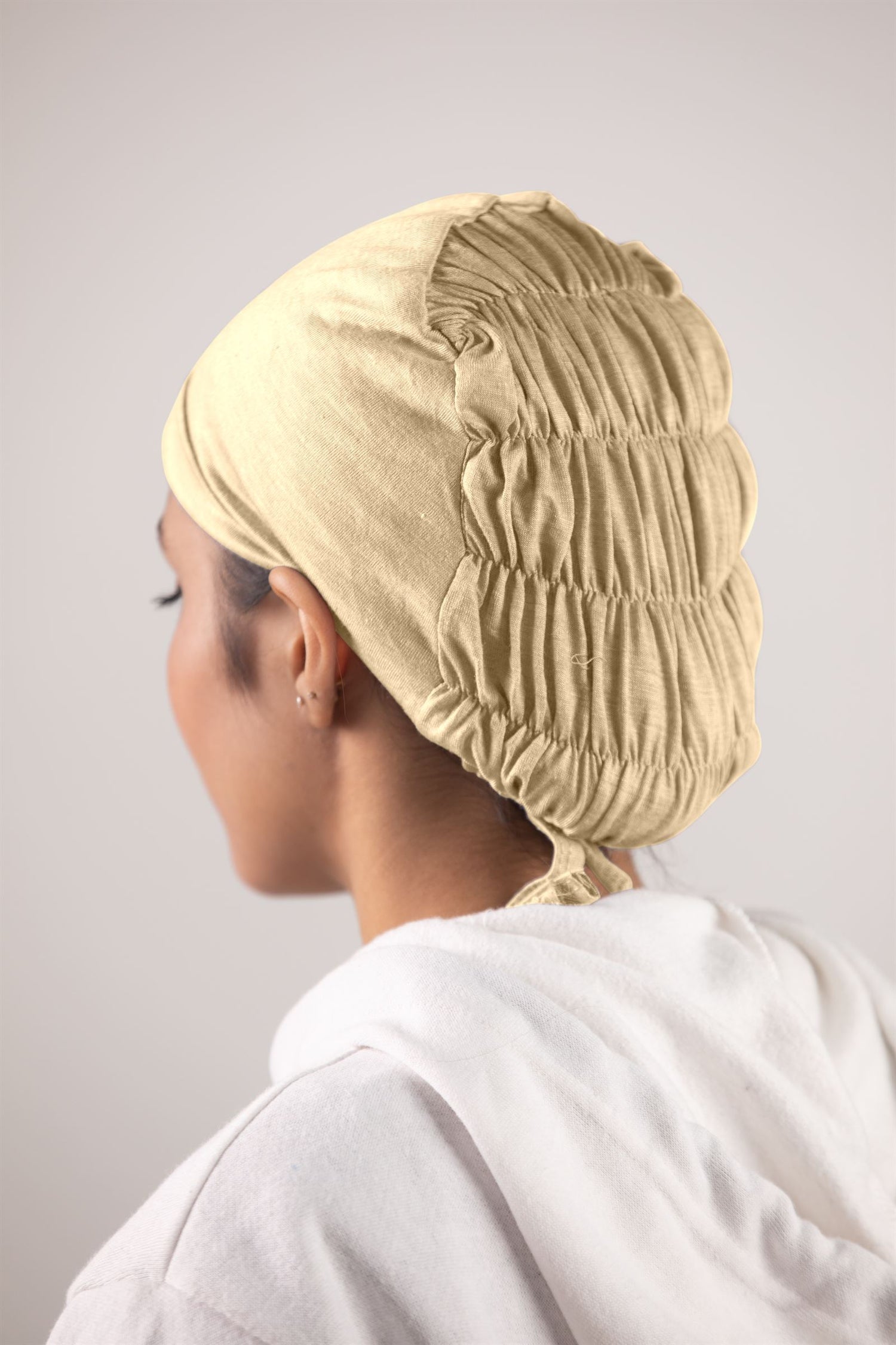 Woman wearing Fawn Ruched Hijab Cap. Soft jersey fabric and ruched details.