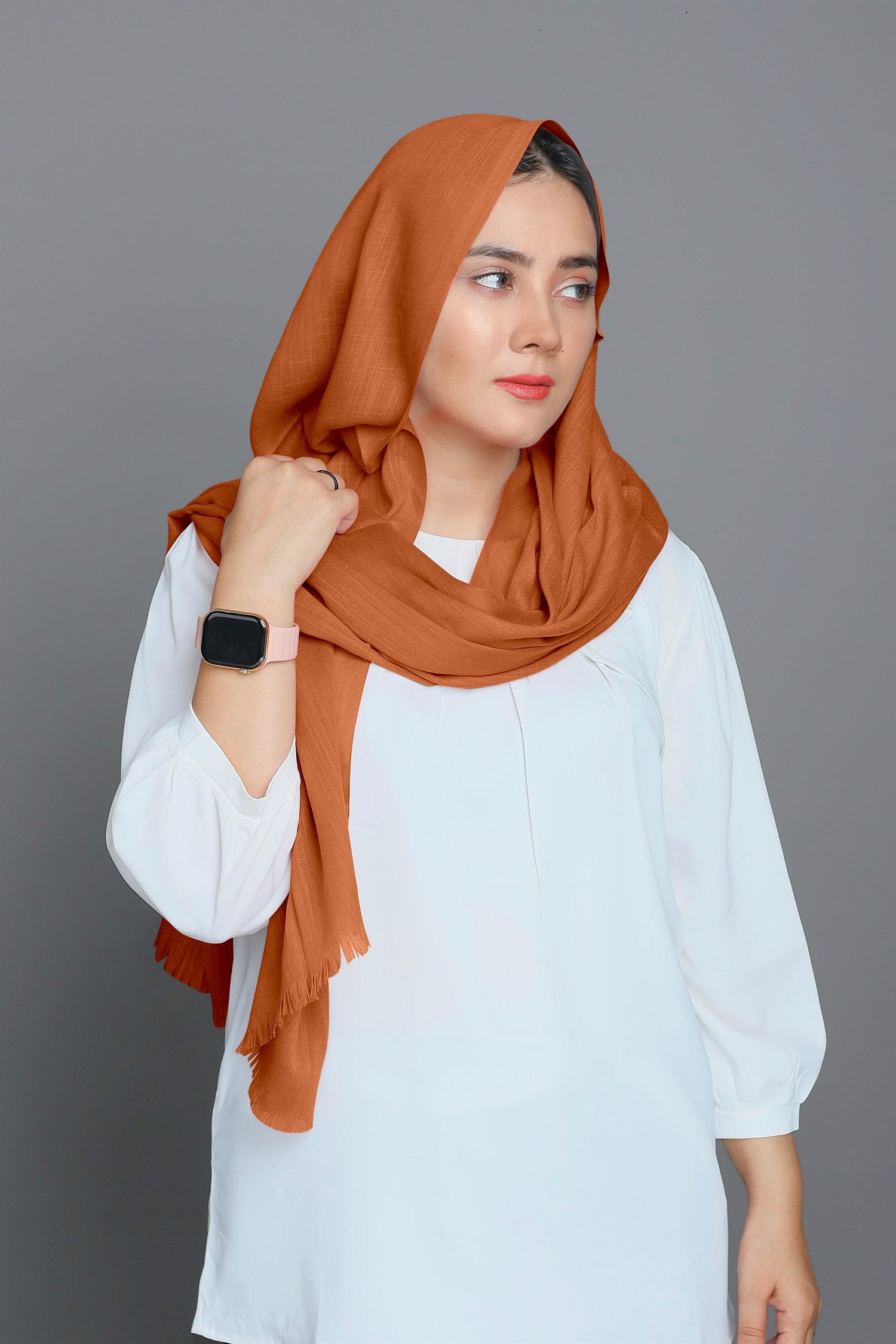 Girl with a charming Apricot hijab, exuding warmth and sophistication in her outfit.