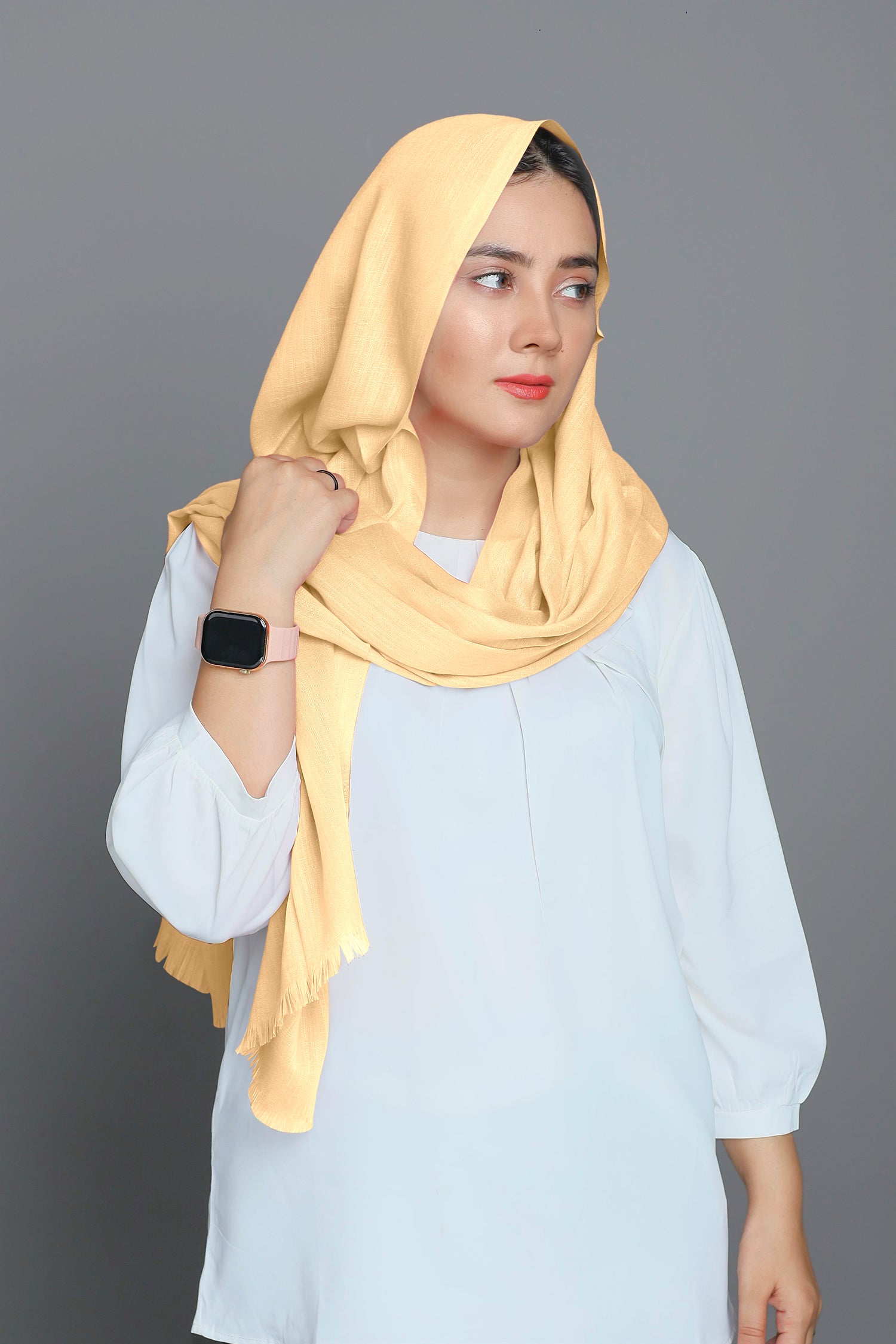 A woman elegantly draped in a Turkish Hijab in a creamy Parmesan shade, showcasing a soft and luxurious look. Made from best cotton viscose fabric.