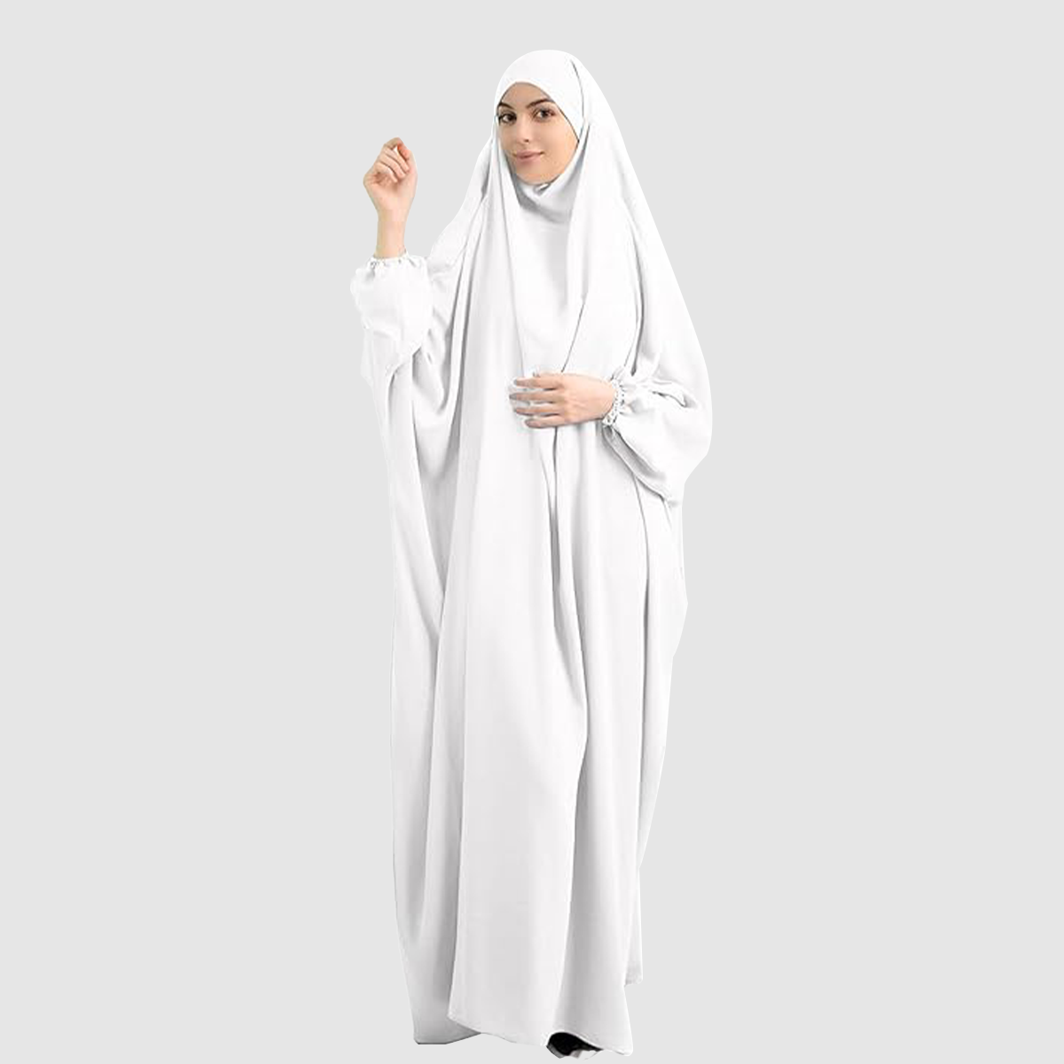 A woman wearing a Namaz Chadar in pure white color looking her straight. Comfortable Prayer Chadar with Sleeves.