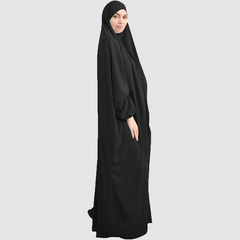 A woman wearing a Namaz Chadar in black color looking her right, side profile