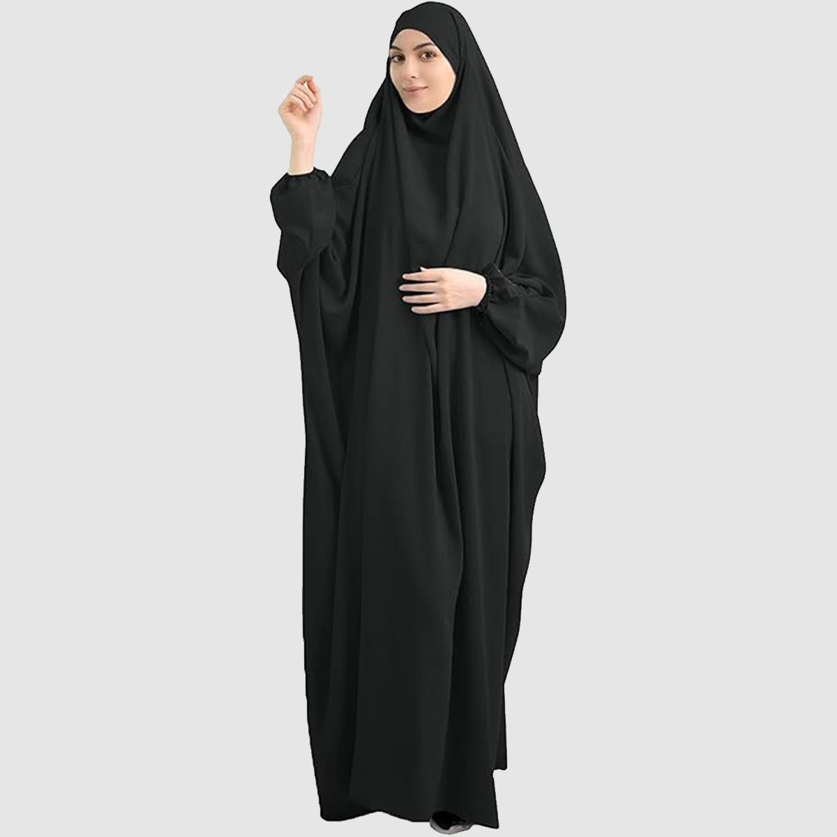 A woman wearing a Namaz Chadar in black color looking her straight. Comfortable & Lightweight Prayer Chadar with sleeves.