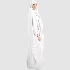 A woman wearing a Namaz Chadar in pure white looking her right, side profile. Elegant & Lightweight Prayer Chadar with Sleeves.