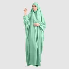 A woman wearing a pure Namaz Chadar with Sleeves in sapphire color, looking straight. Lightweight & Soft Chaddar. Perfect for Salah prayers and every occasion.