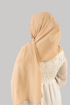 a women wearing instant hijab with cap in beige color georgette material back side