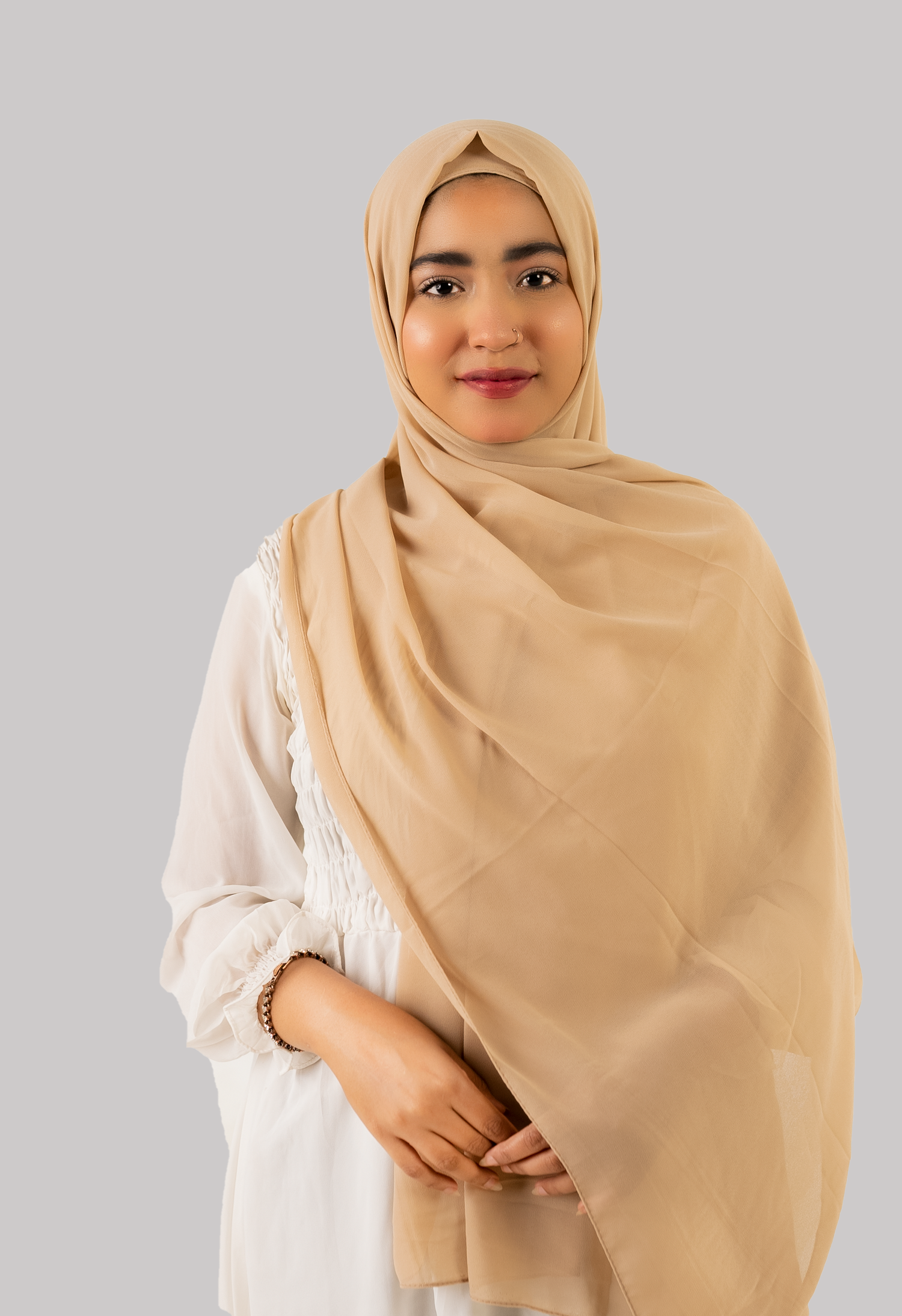 a women wearing instant hijab with cap in beige color georgette material front side. 