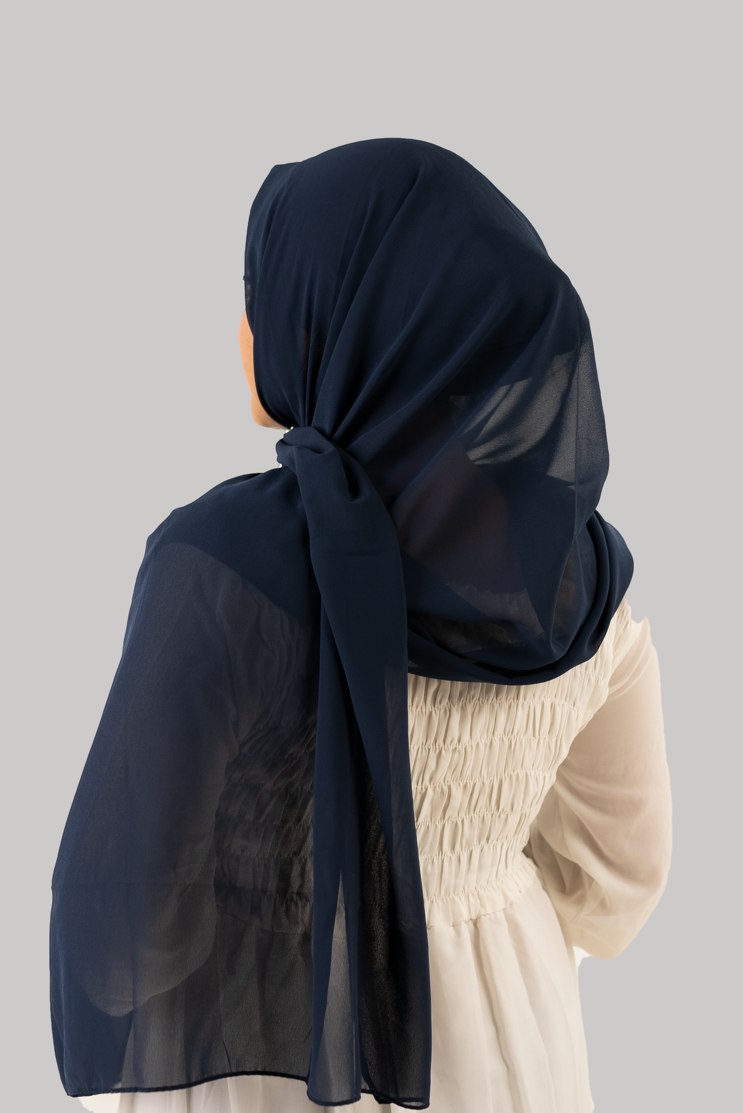 a women wearing instant hijab with cap in navy blue color georgette material back side