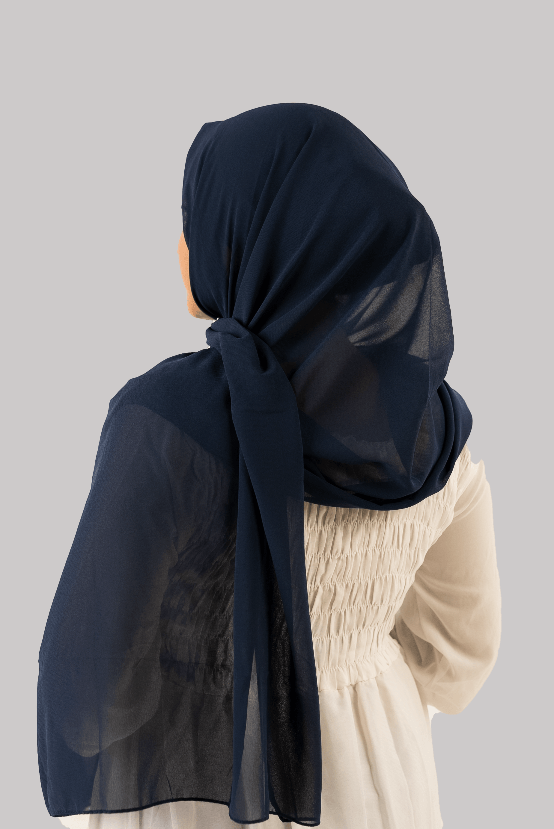 a women wearing instant hijab with cap in navy blue color georgette material back side