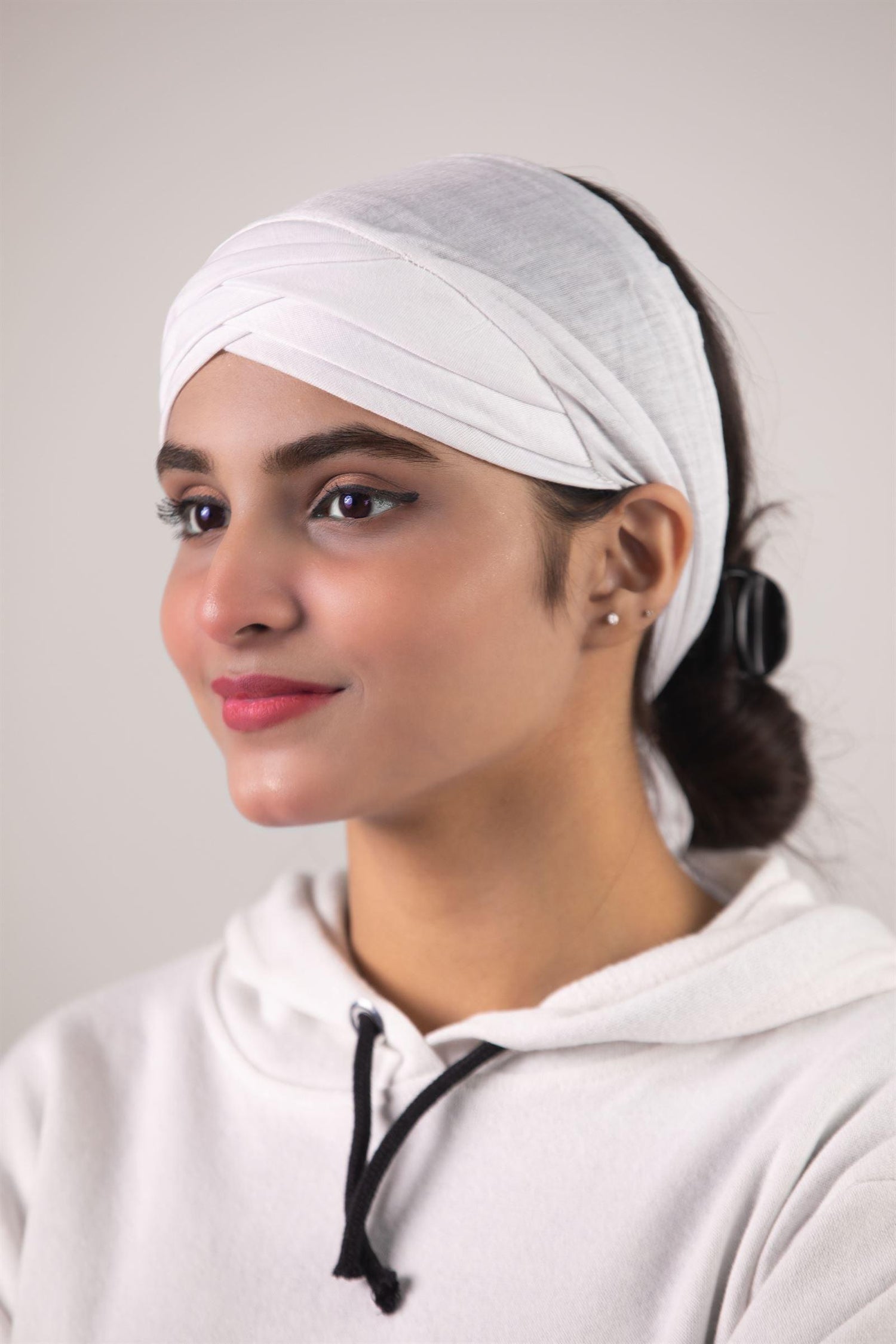 Woman Weating Criss Cross Hijab Cap in White color. Cross front style hijab undercap.