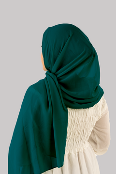 a women wearing instant hijab with cap in teal color, georgette material,