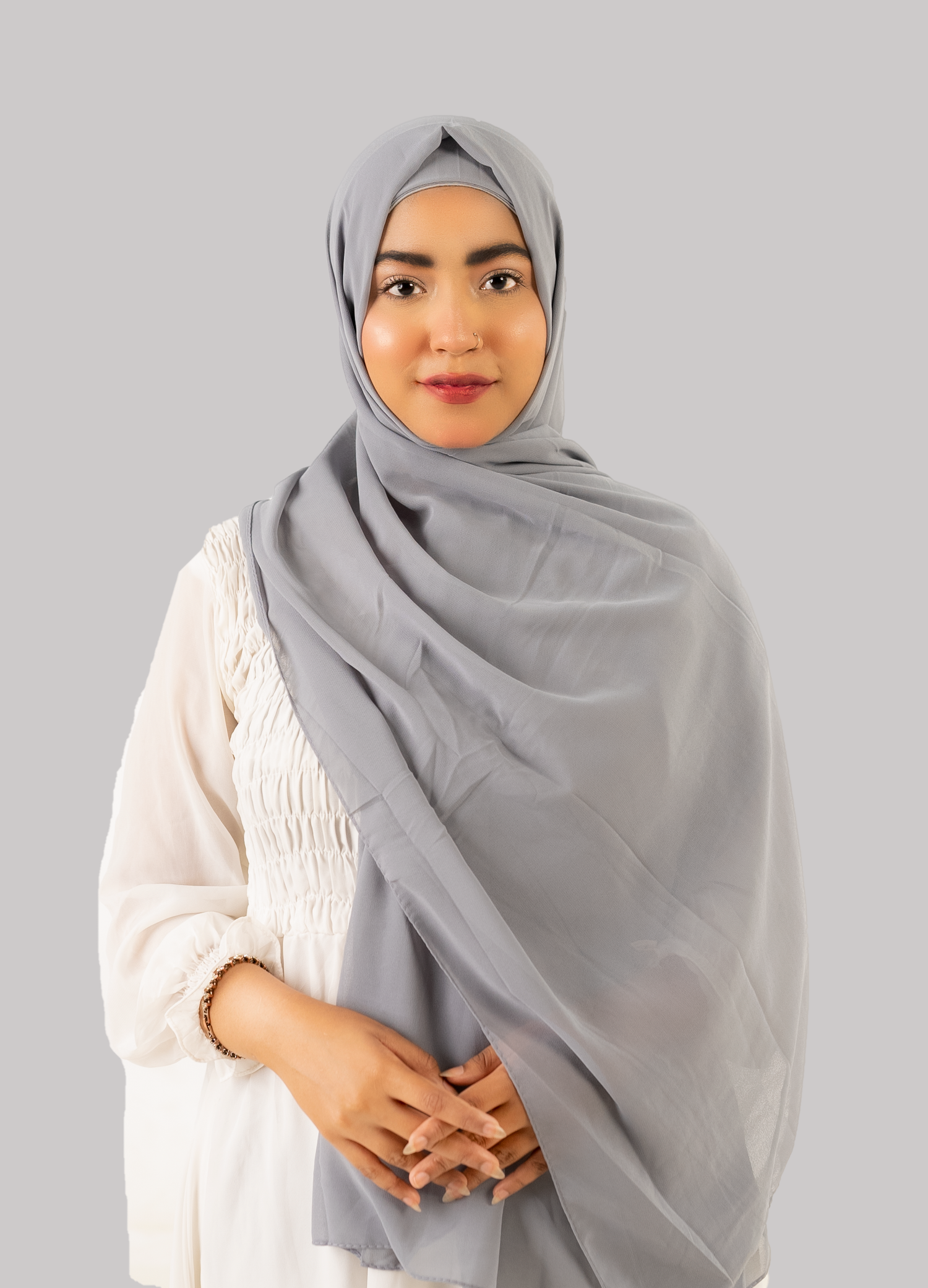 a women wearing georgette instant hijab with cap in grey color front side. 