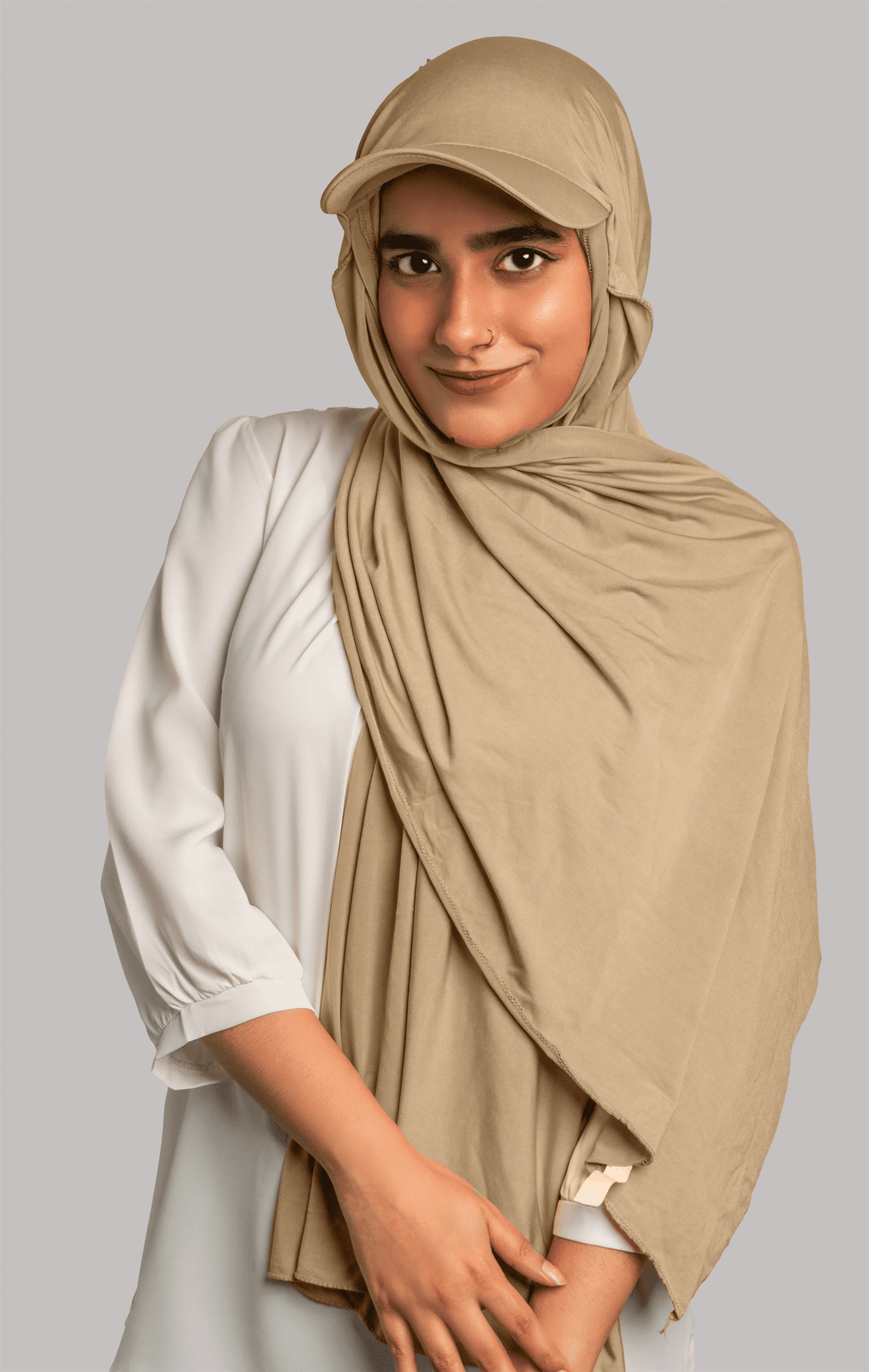 Girl wearing stylish hat hijab in light khaki color. looking front.