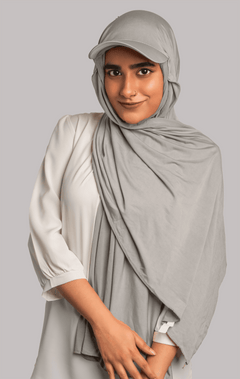 Girl Wearing Stylish Hat Hijab in grey color. looking front.