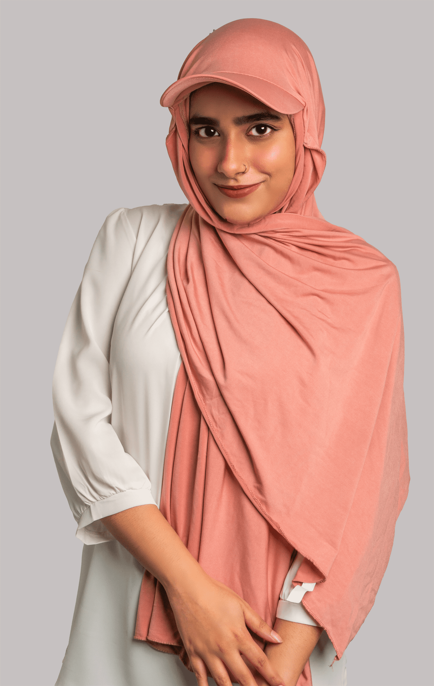 A women wearing a stylish Hat Hijab in pink color.