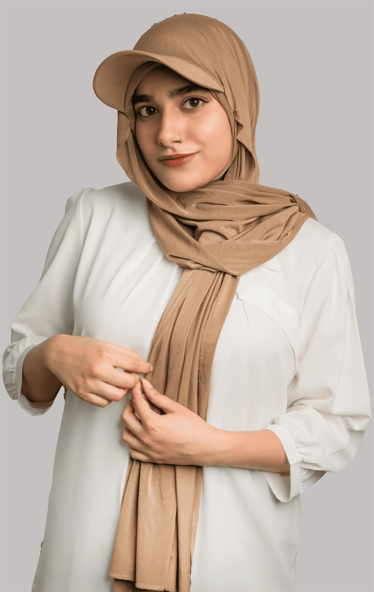 Elegant woman styling in a Brown Hat Hijab, combining practicality and fashion