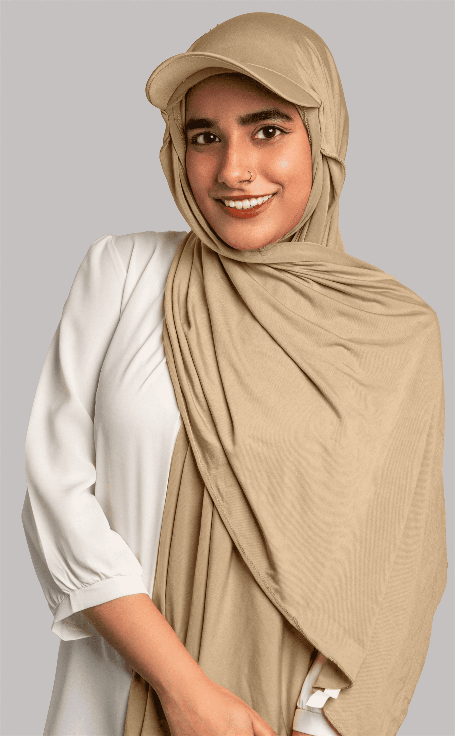 Girl wearing stylish hat hijab in light khaki color. looking front.